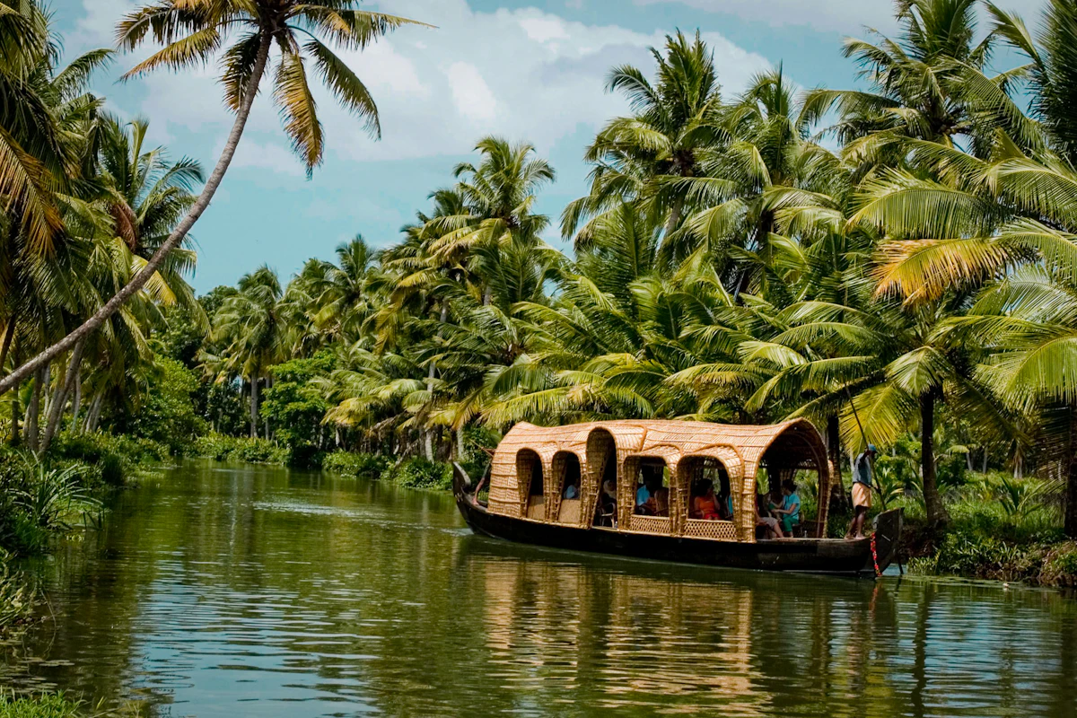 A Kerala houseboat on the backwaters among palm trees