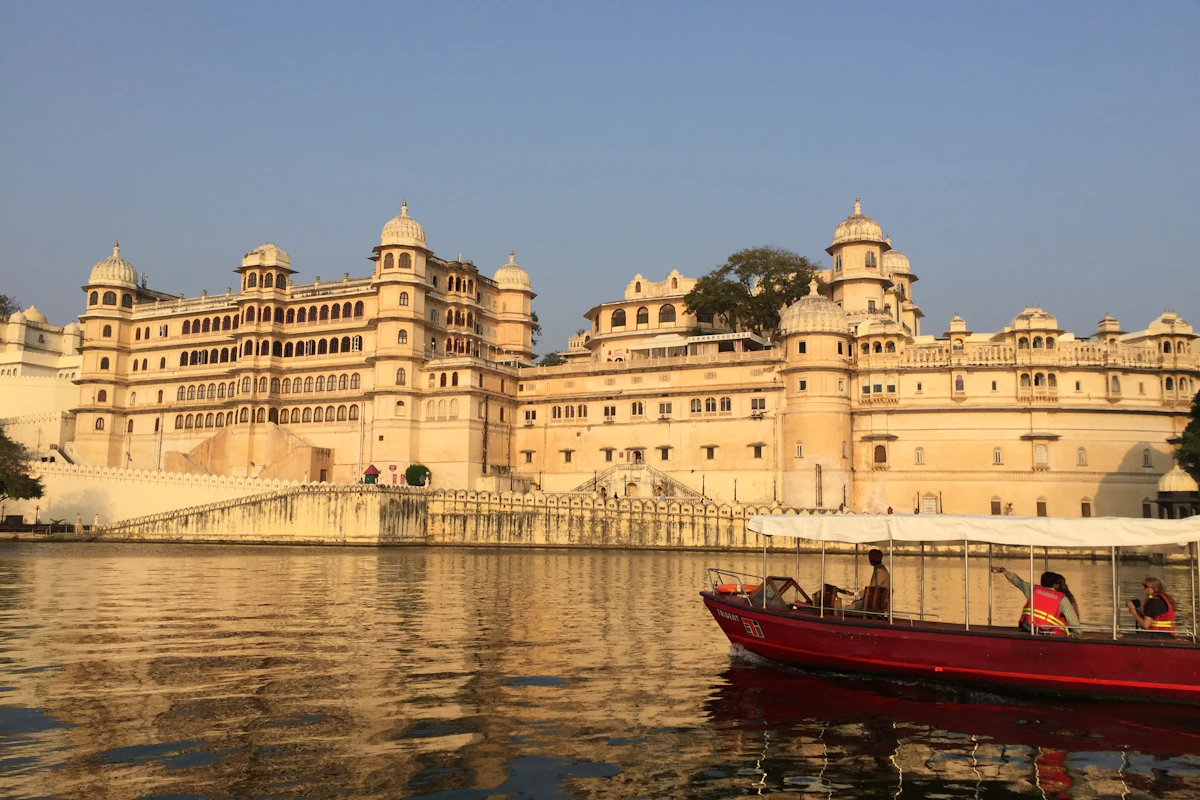 A golden palace reflected in a lake in Udaipur